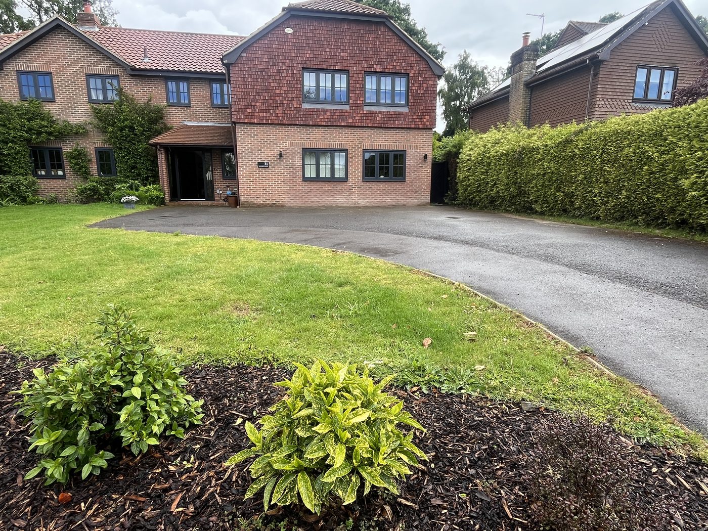 Old worn tarmac driveway before tar and chip