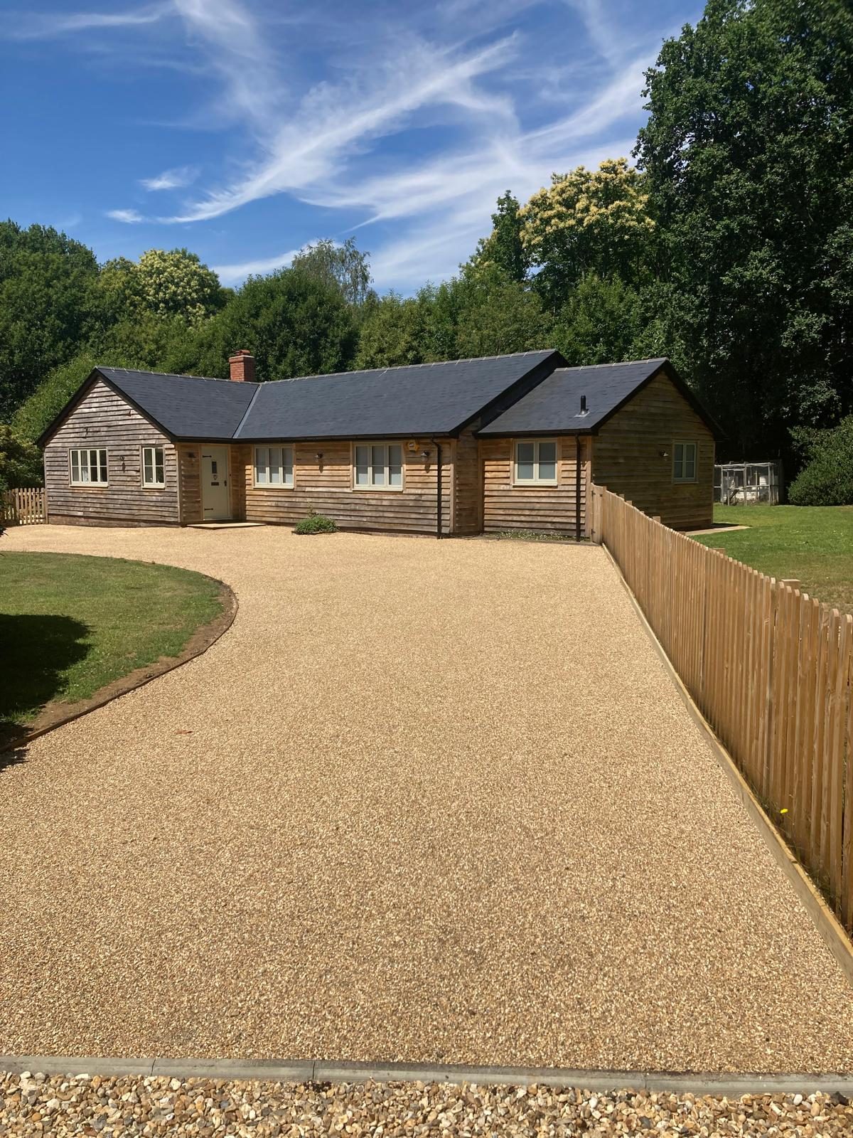 Completed golden tar and chip driveway at a timber cottage